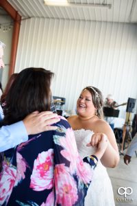 Bride laughing with guests.