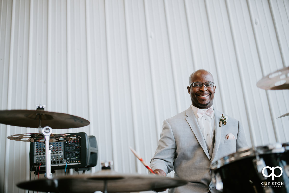 Groom playing drums at the reception.