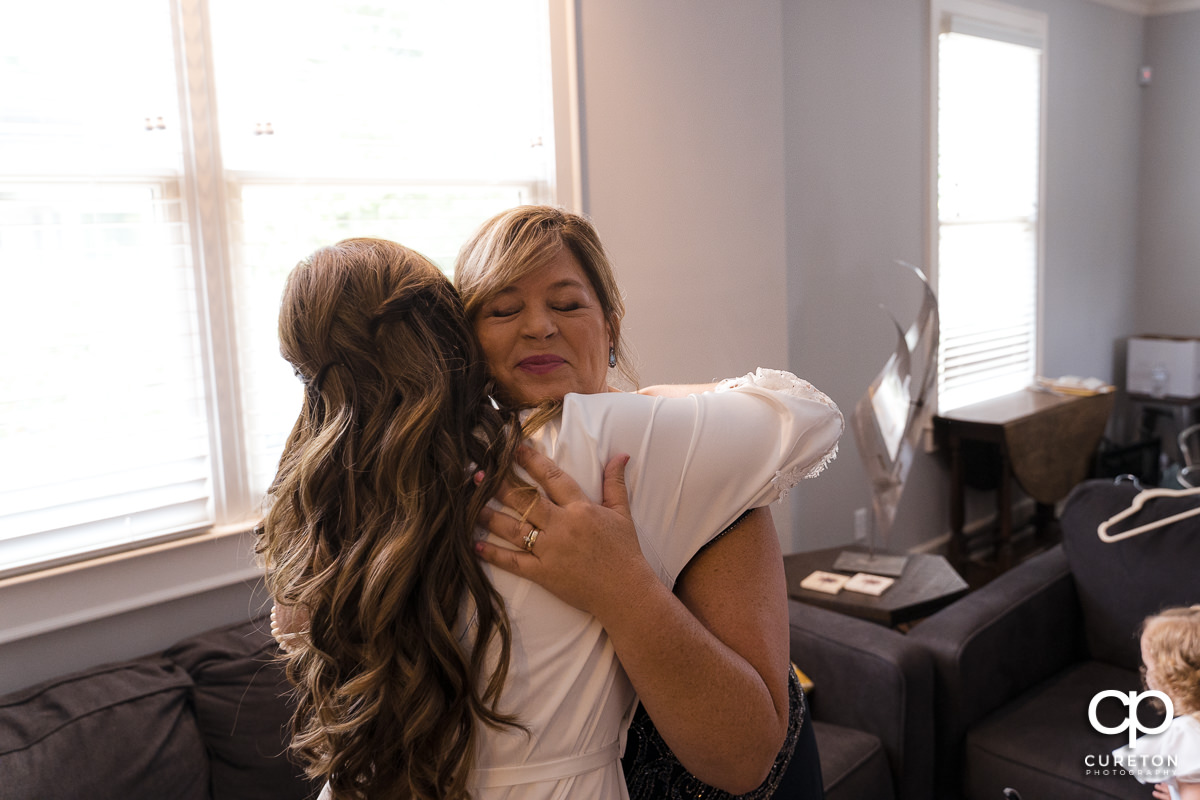 Bride hugging the groom's mother before the wedding.