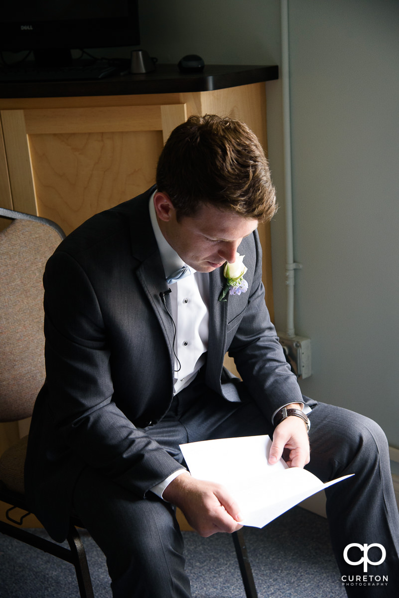 Groom reading a letter from his bride.