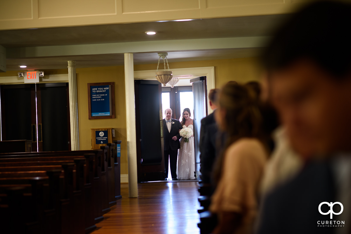 Bride making an entrance to the wedding at Grace Church in Greenville,SC.