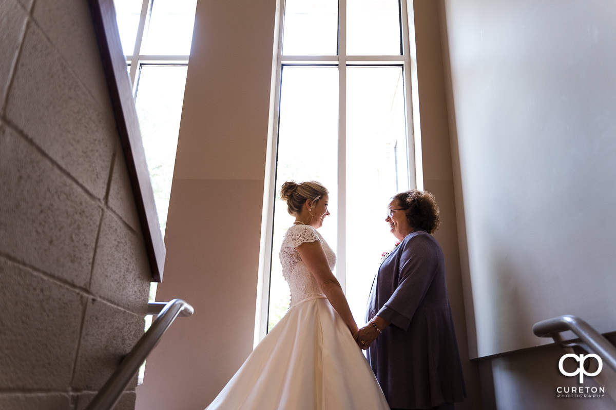 Bride and her mother sharing a moment before the ceremony.