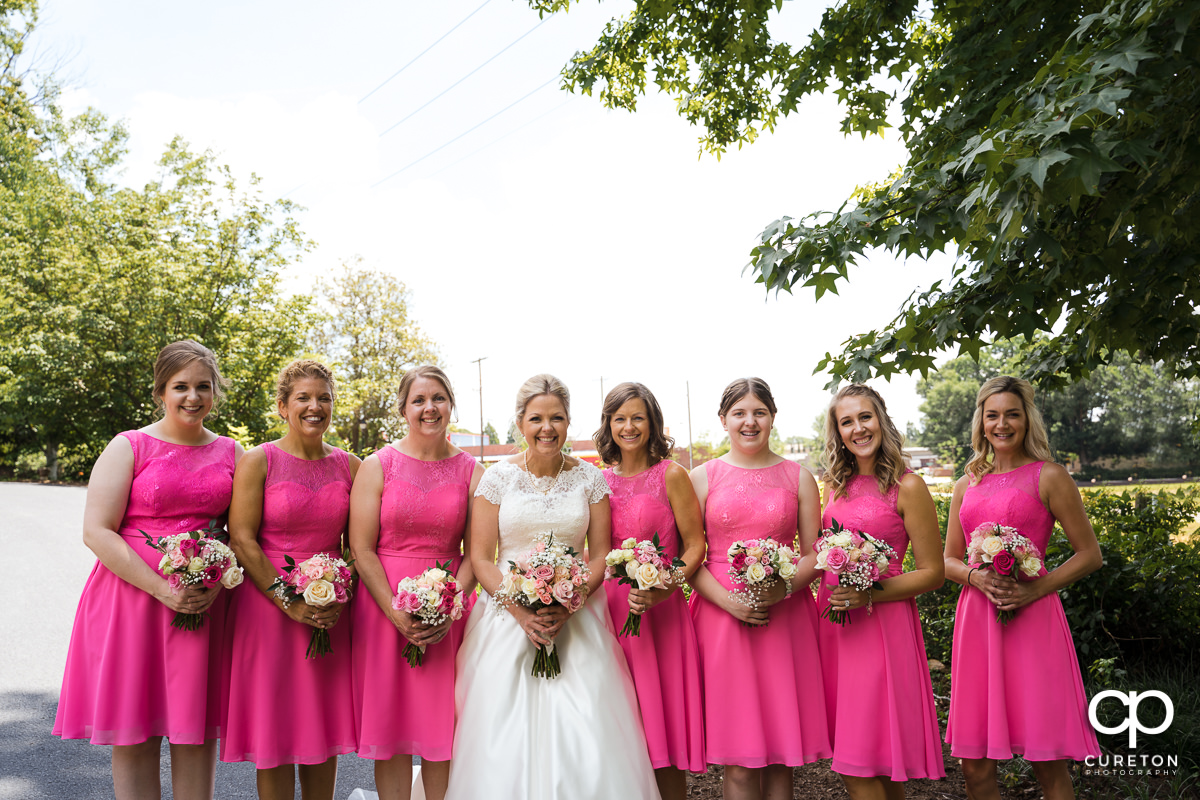 Bride and bridesmaids holding flowers.