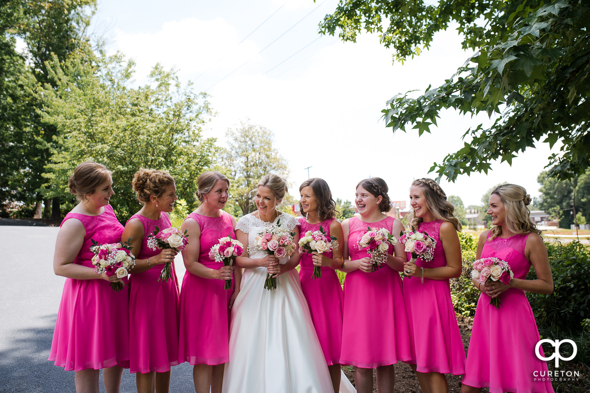 Bride laughing with her bridesmaids.