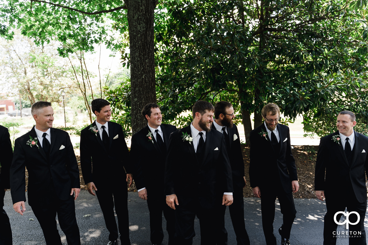 Groom and his groomsmen laughing.