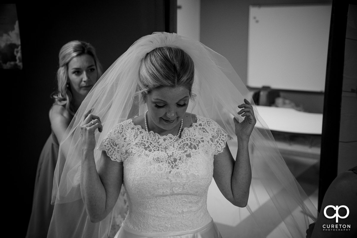 Bride putting her veil in.