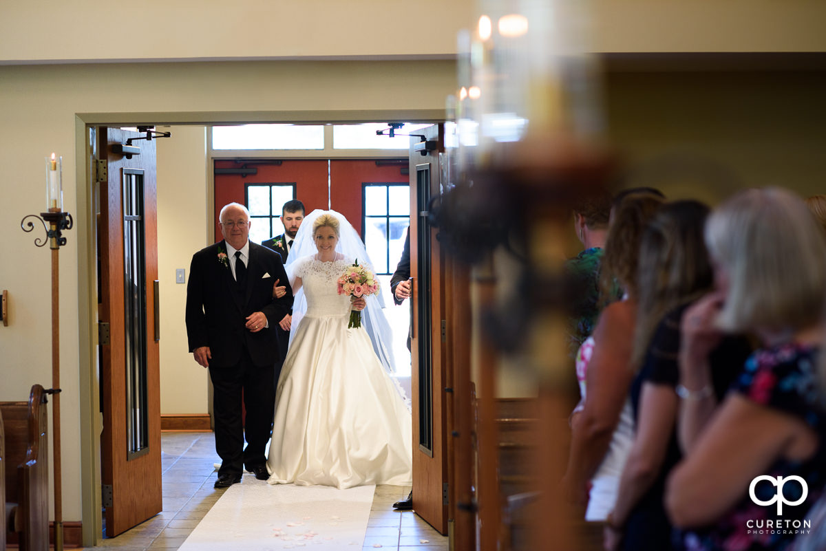 Bride walking down the aisle with her father.
