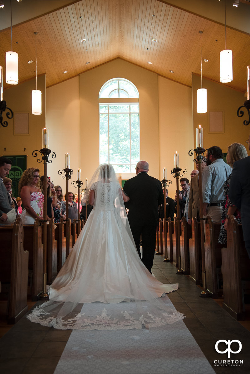 Bride and her dad walking down the aisle.