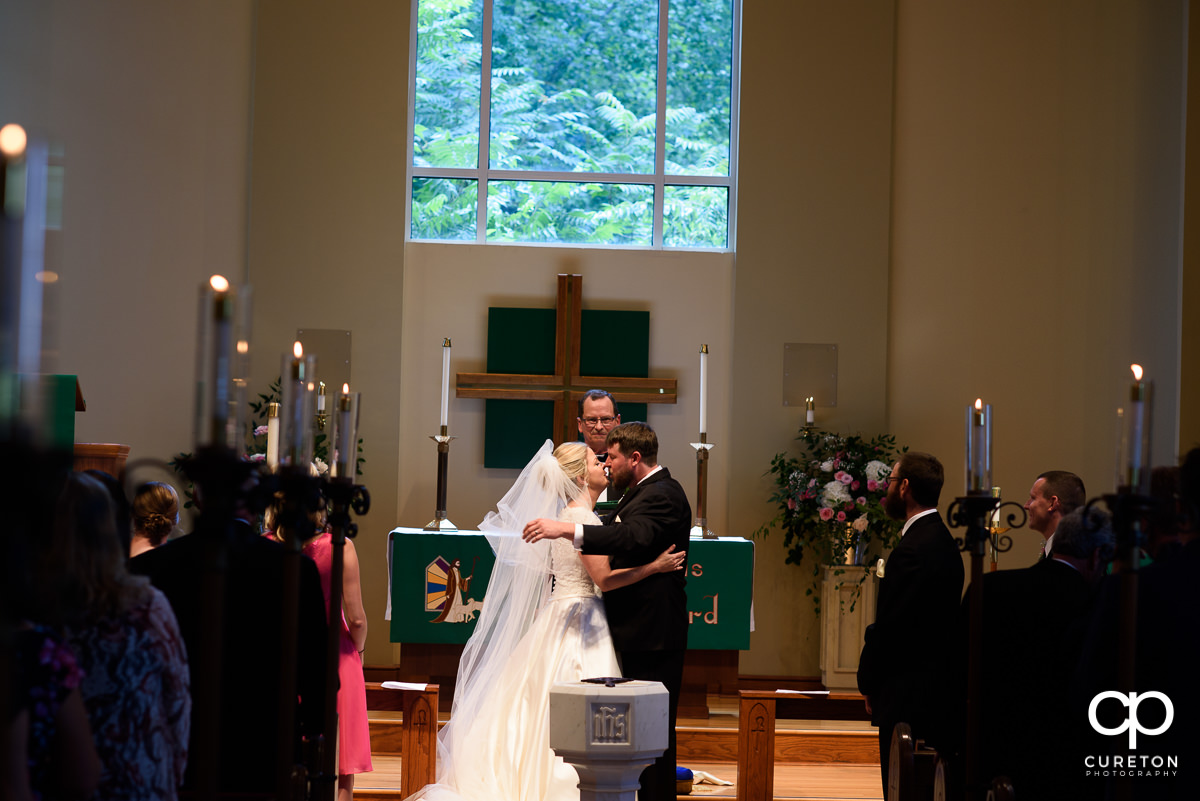 First kiss at the church wedding ceremony.