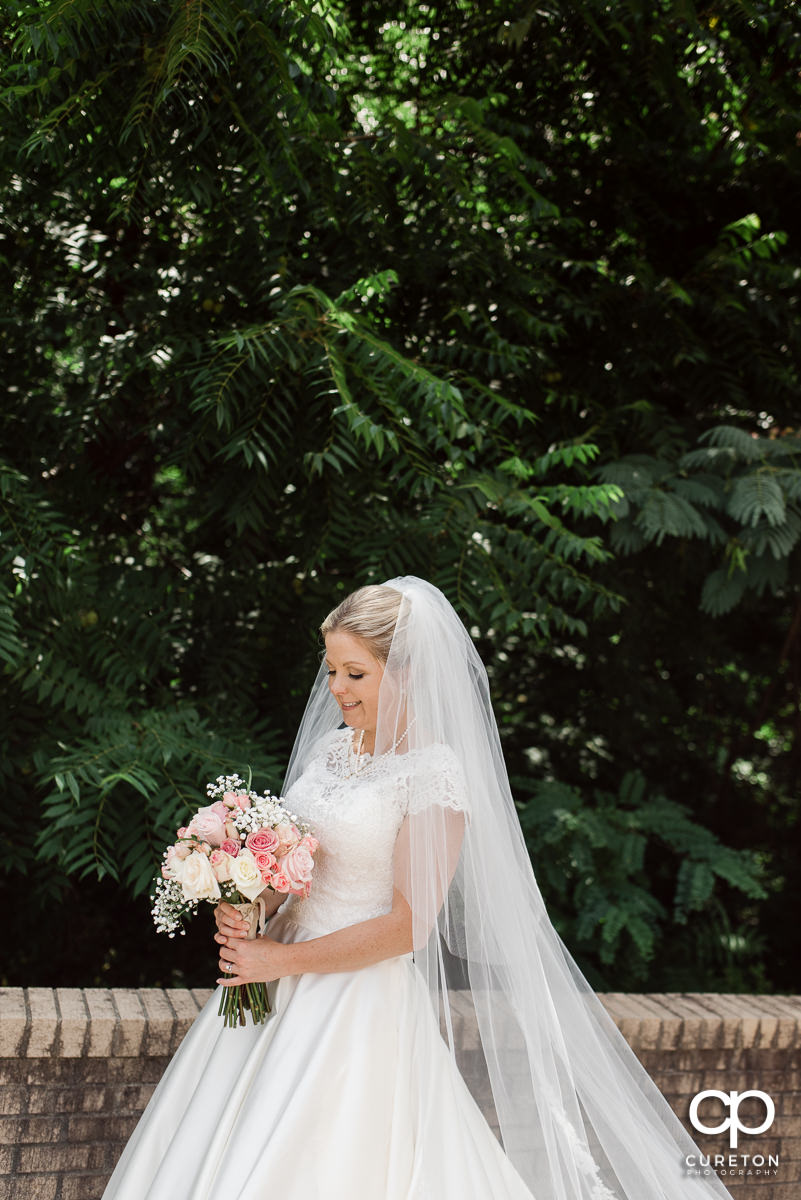 Bride looking at her flowers.