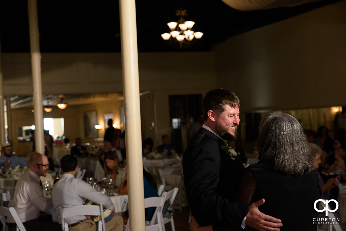 Groom and his mom dancing.