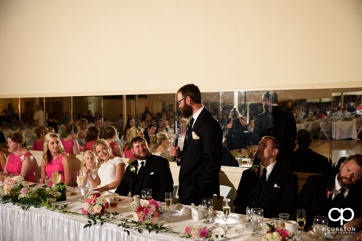 Best man giving a speech at the reception.