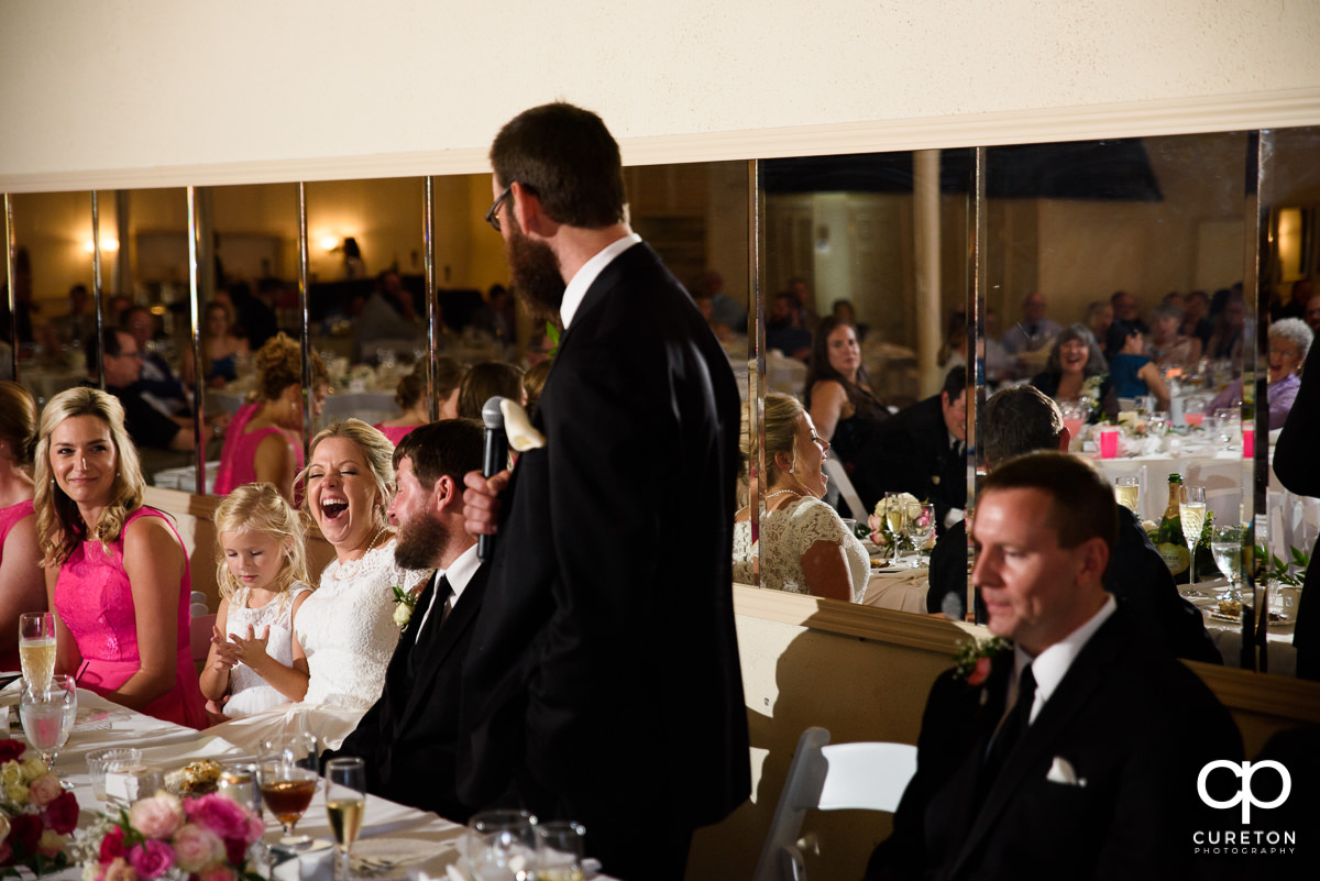 Bride laughing at the best man's speech