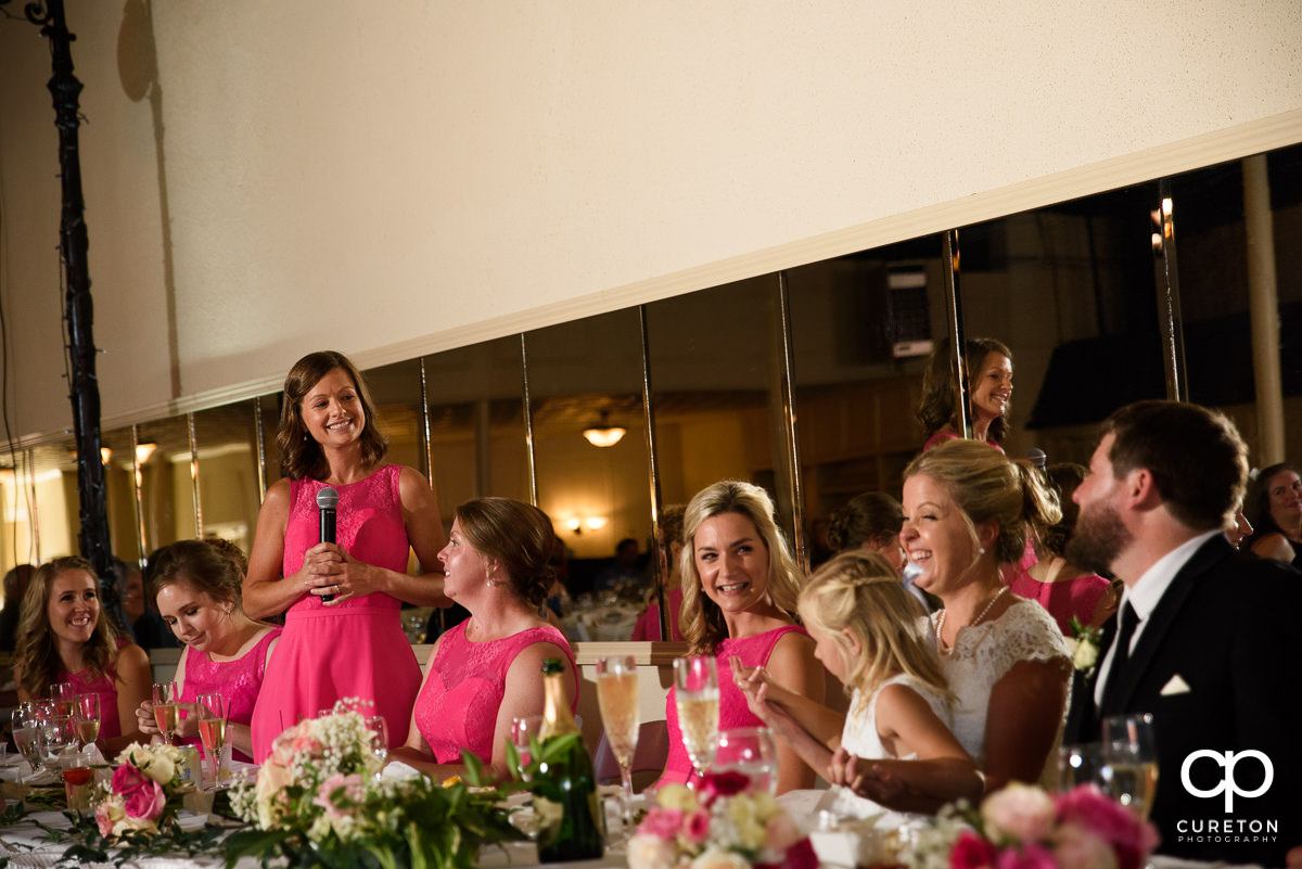 Bride's friend giving a speech at the wedding reception.