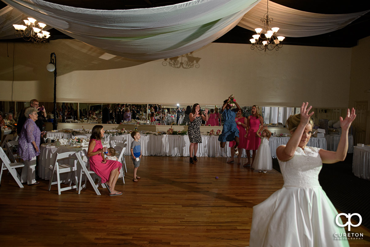 Bride tossing her flowers.