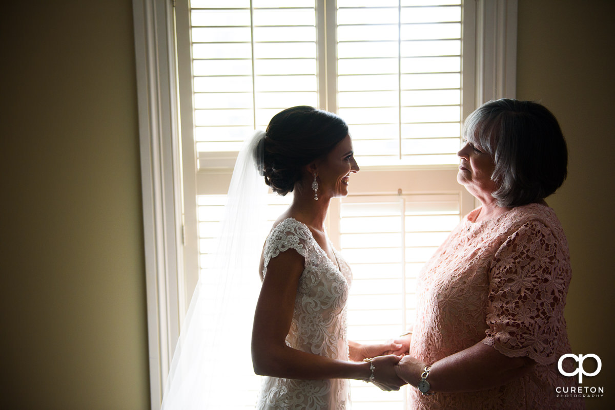 Bride holding hands with her mom before the wedding ceremony at Green Valley Country Club.