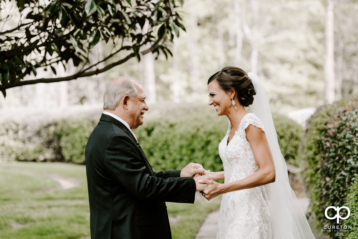 Bride holding hand with her dad.
