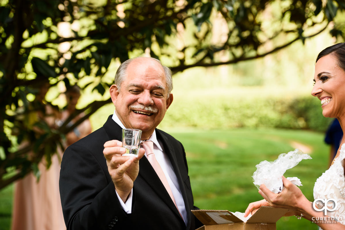 Bride giving her dad a gift before the ceremony.