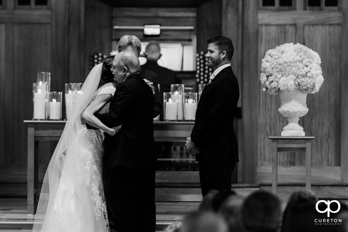 Father giving away his daughter at her wedding.