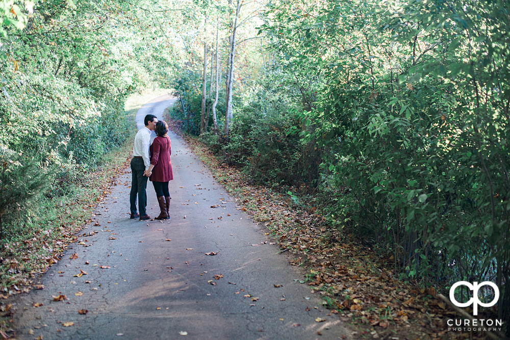 Engaged couple walking down the road.