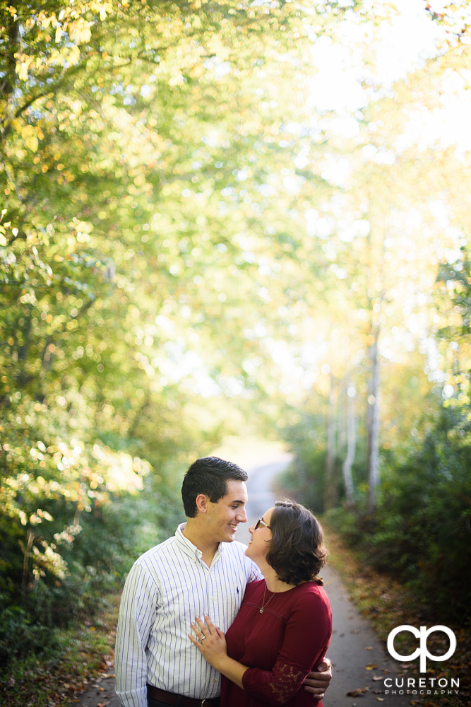 Engaged couple standing in beautiful light.