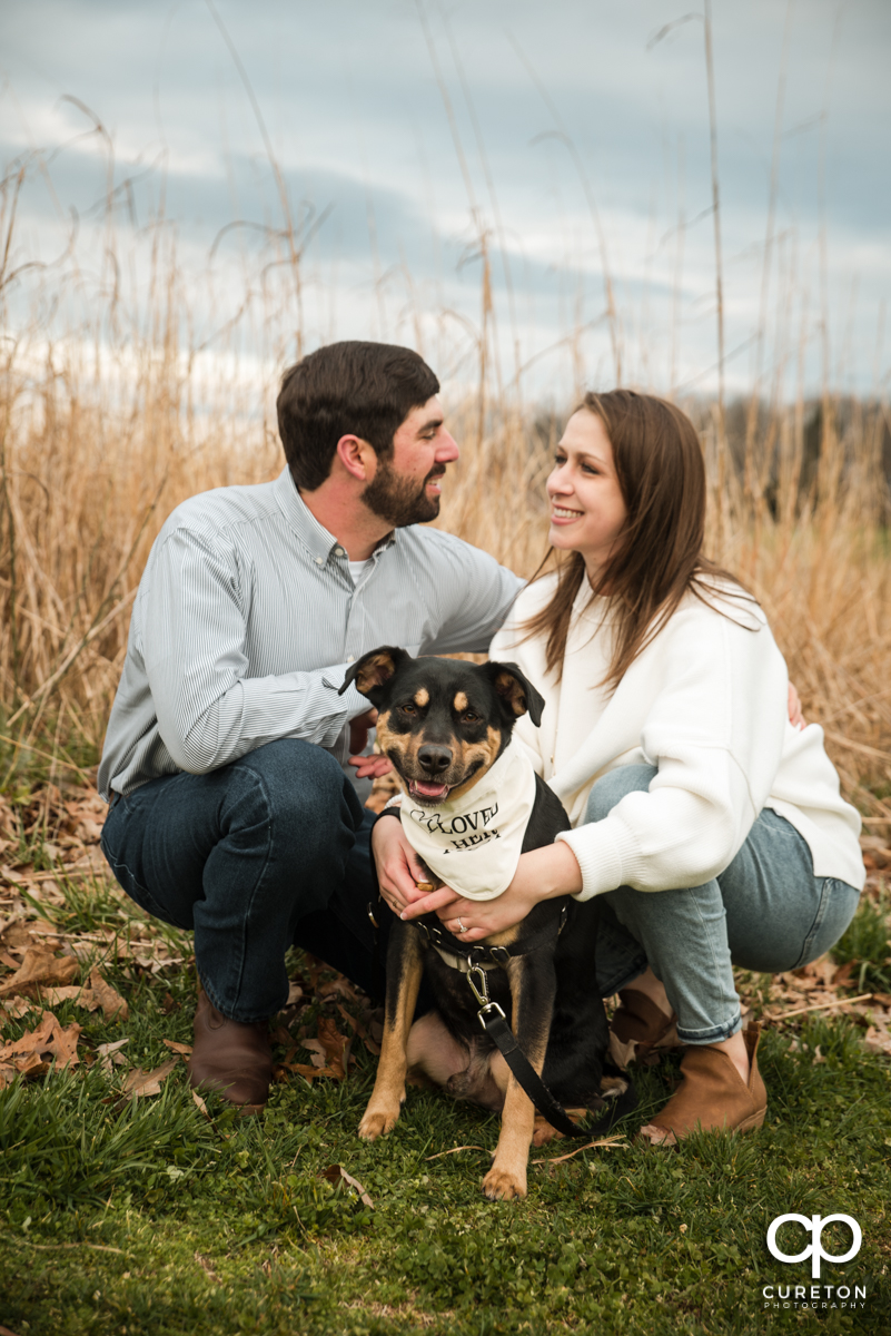 Engaged couple with their dog.