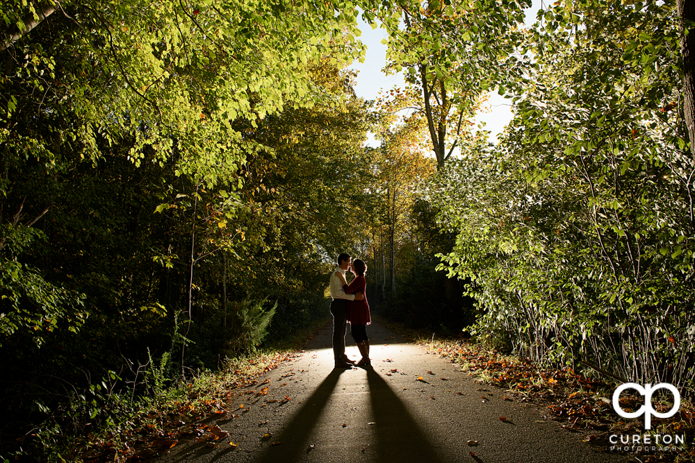 Backlit photo of a couple during their engagement session at Greenbrier farms.