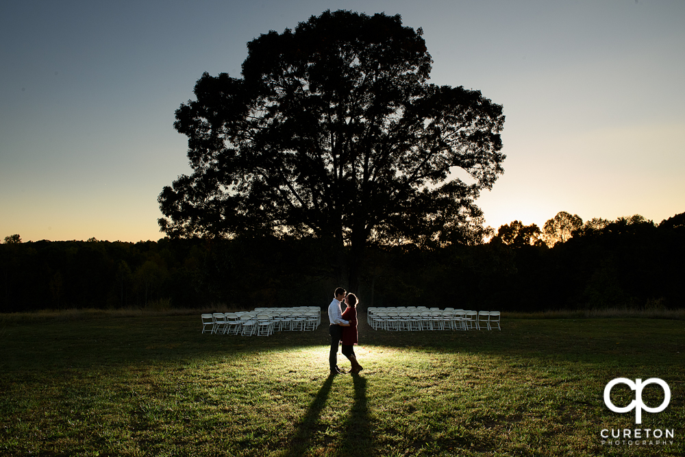 Engaged couple near the tree at Greenbrier farms.