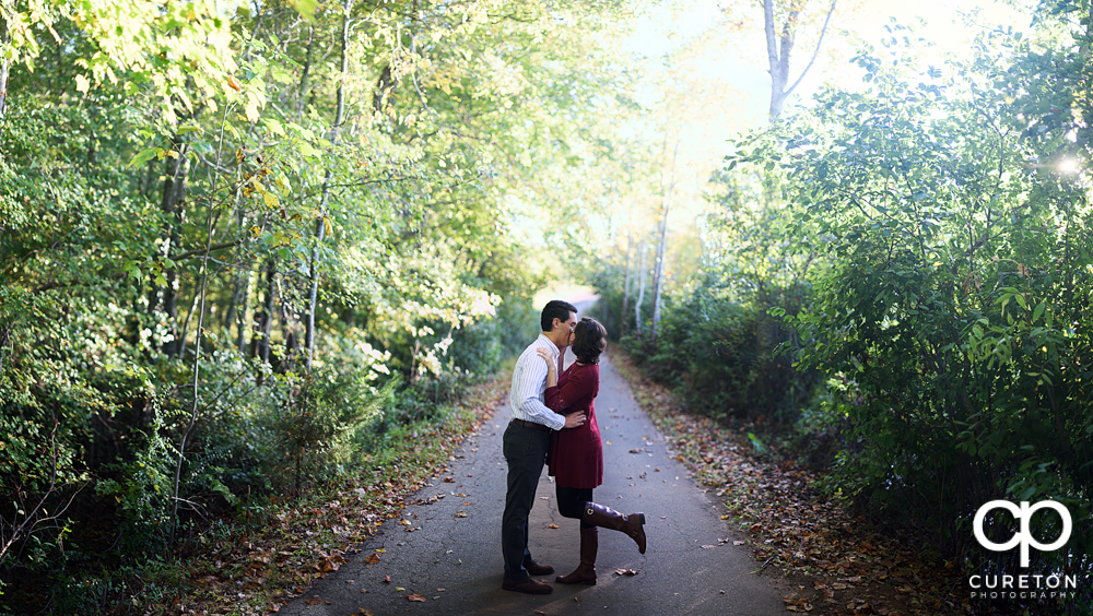 Couple kissing during their engagement session.