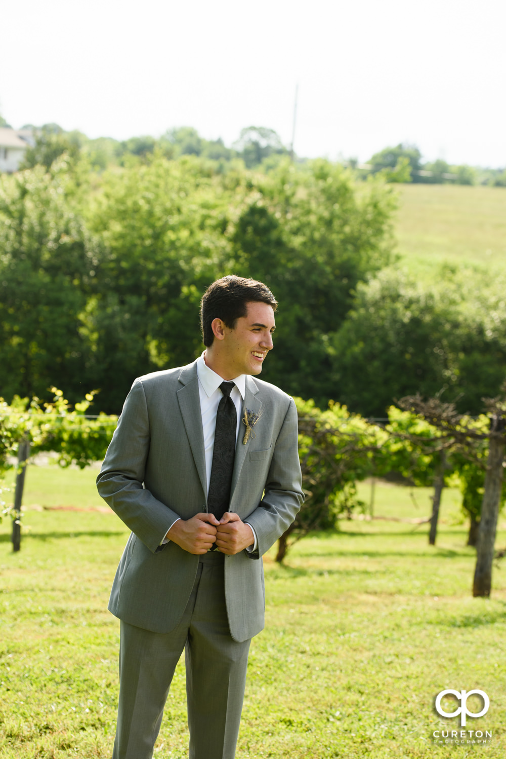 Groom standing in the vineyard at Greenbrier Farms.