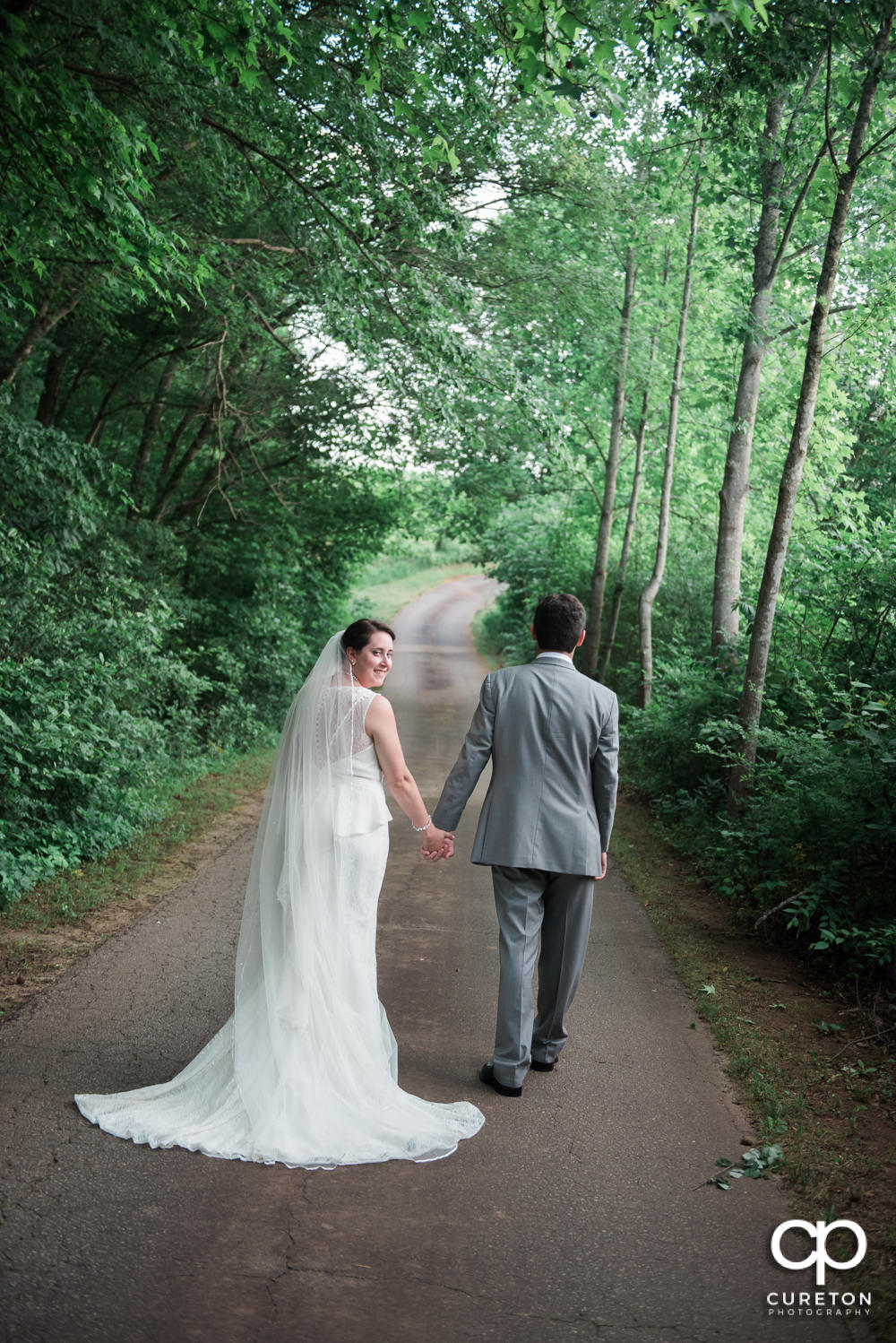 Bride and groom walking down the road.