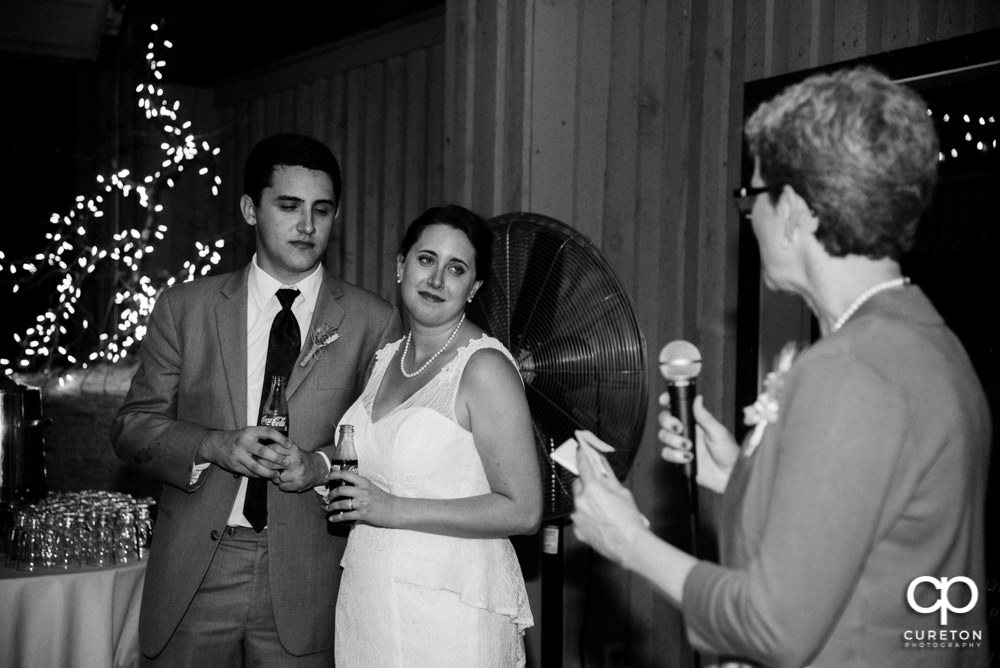 Bride and groom watching a toast.