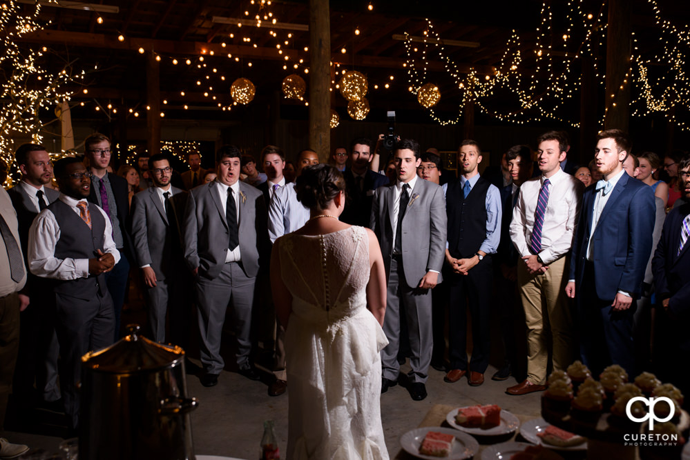Groom's fraternity singing to his bride at their wedding reception.