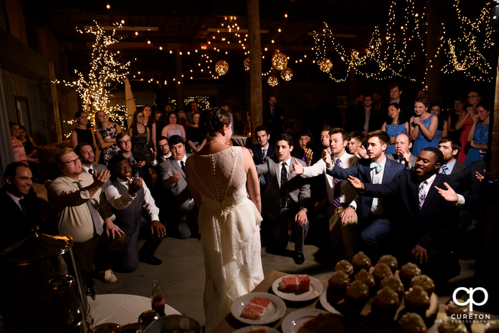 Groom's fraternity singing to his bride at their wedding reception.