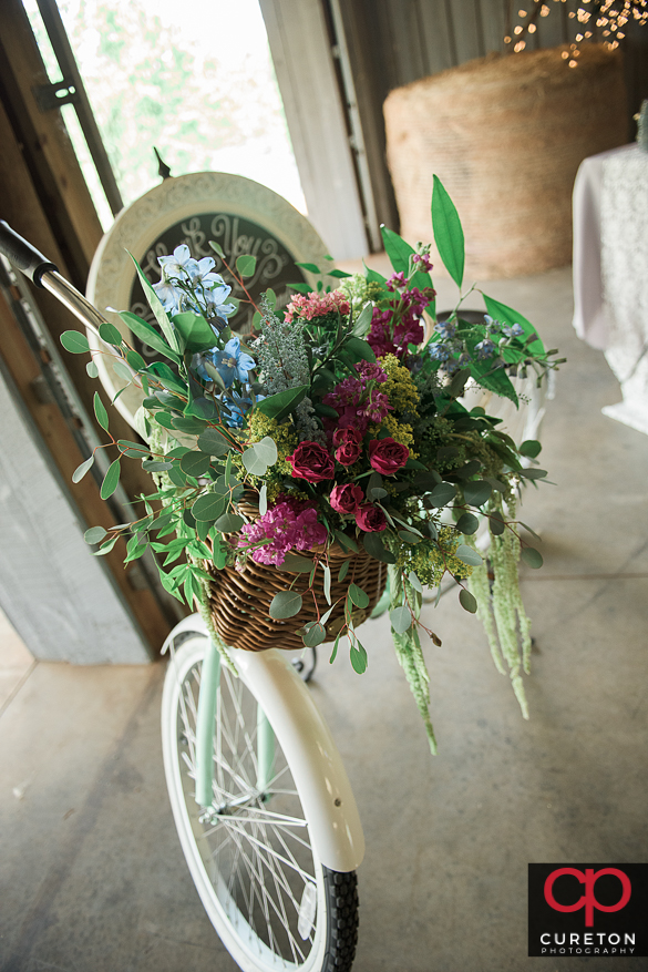 Awesome vintage bicycle adorned with flowers at a rustic farm wedding.