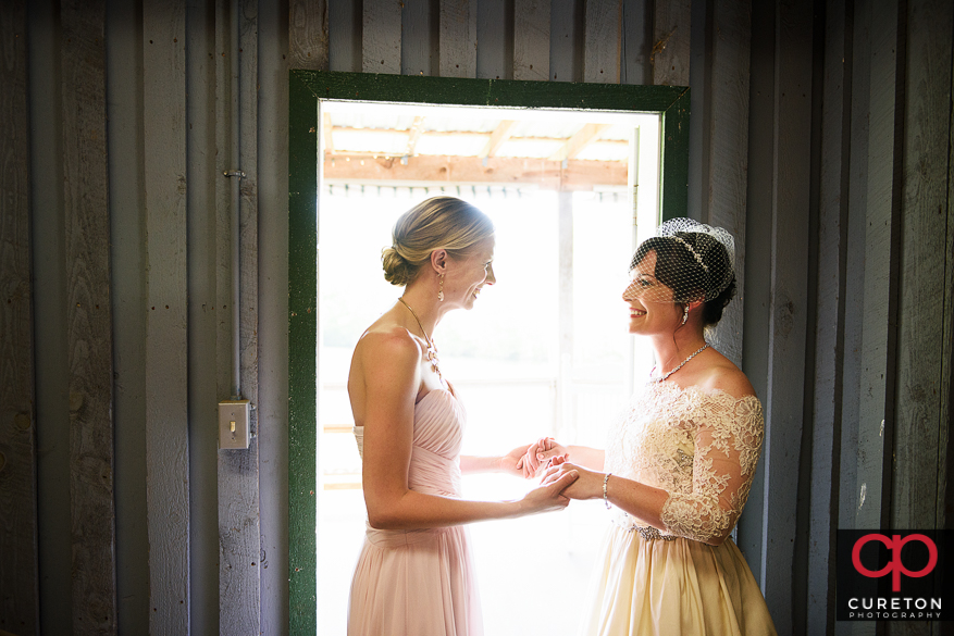Bride and maid of honor standing in the doorway.