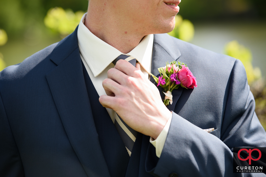 Closeup of groom and his tie.