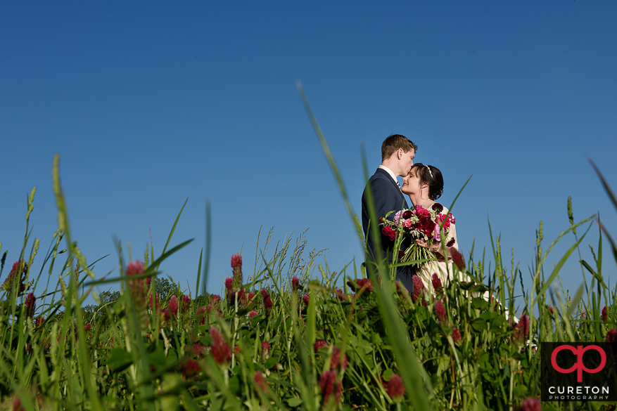 Bride and groom in a field on the farm