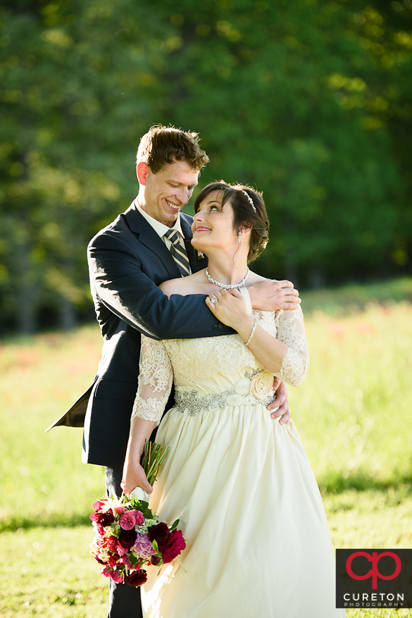 Epic bride and groom near the tree at Greenbrier farms after their wedding.