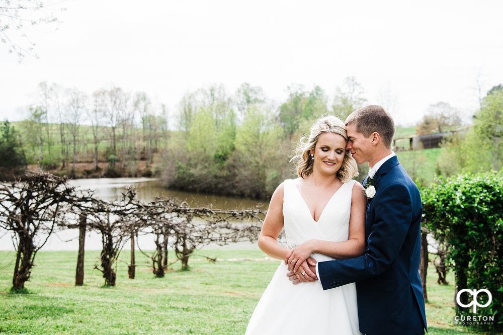 Bride and groom in the vineyard before their wedding at Greenbrier Farms in Easley, SC.