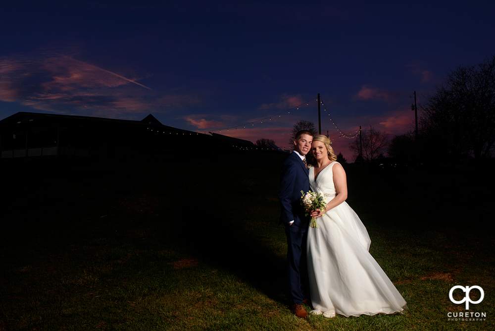 Bride and groom at sunset during their wedding reception at Greenbrier Farms in Easley, SC.