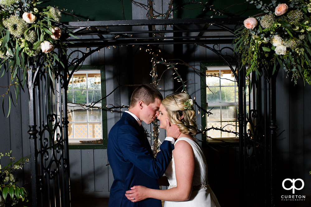 Bride and groom at an indoor wedding at Greenbrier Farms.