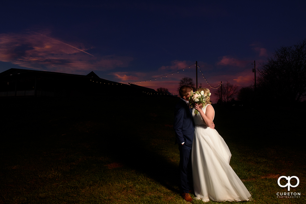 Bride and Groom kissing at sunset.