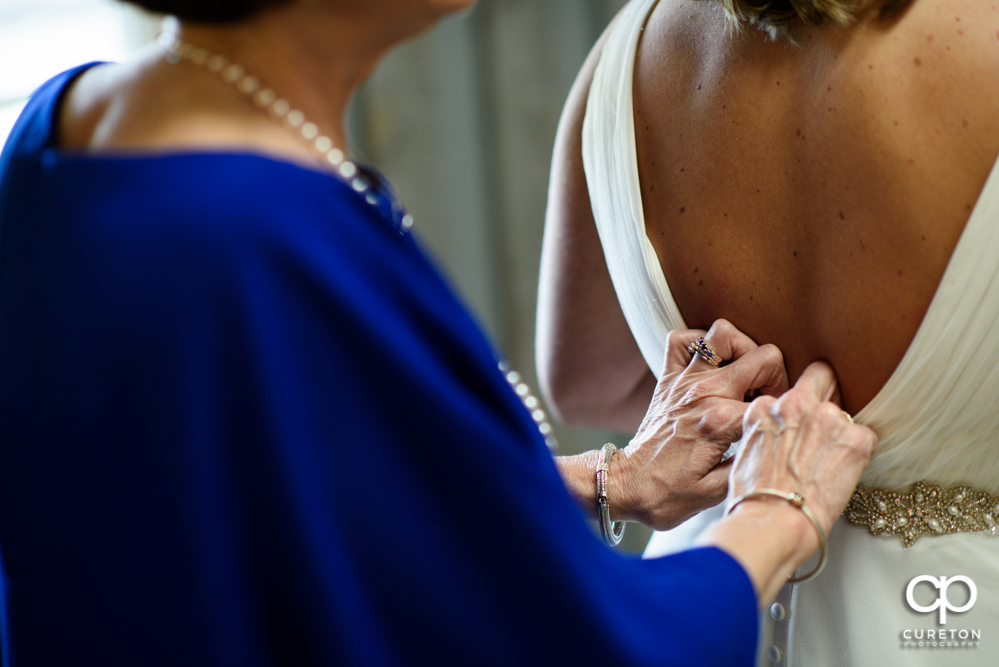 Bride getting into the dress.