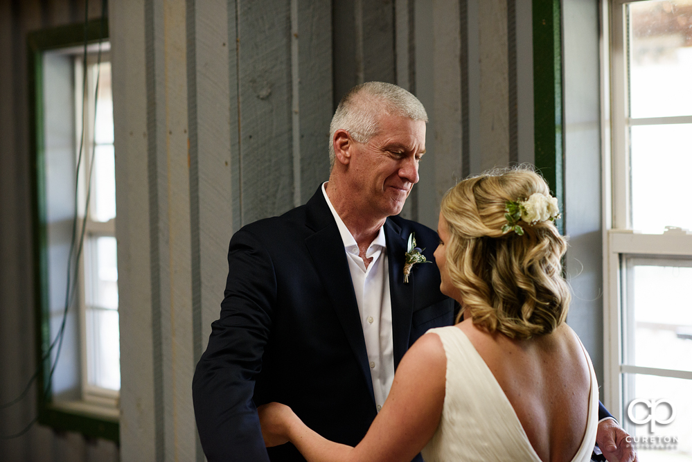 Bride and father first look before the wedding.