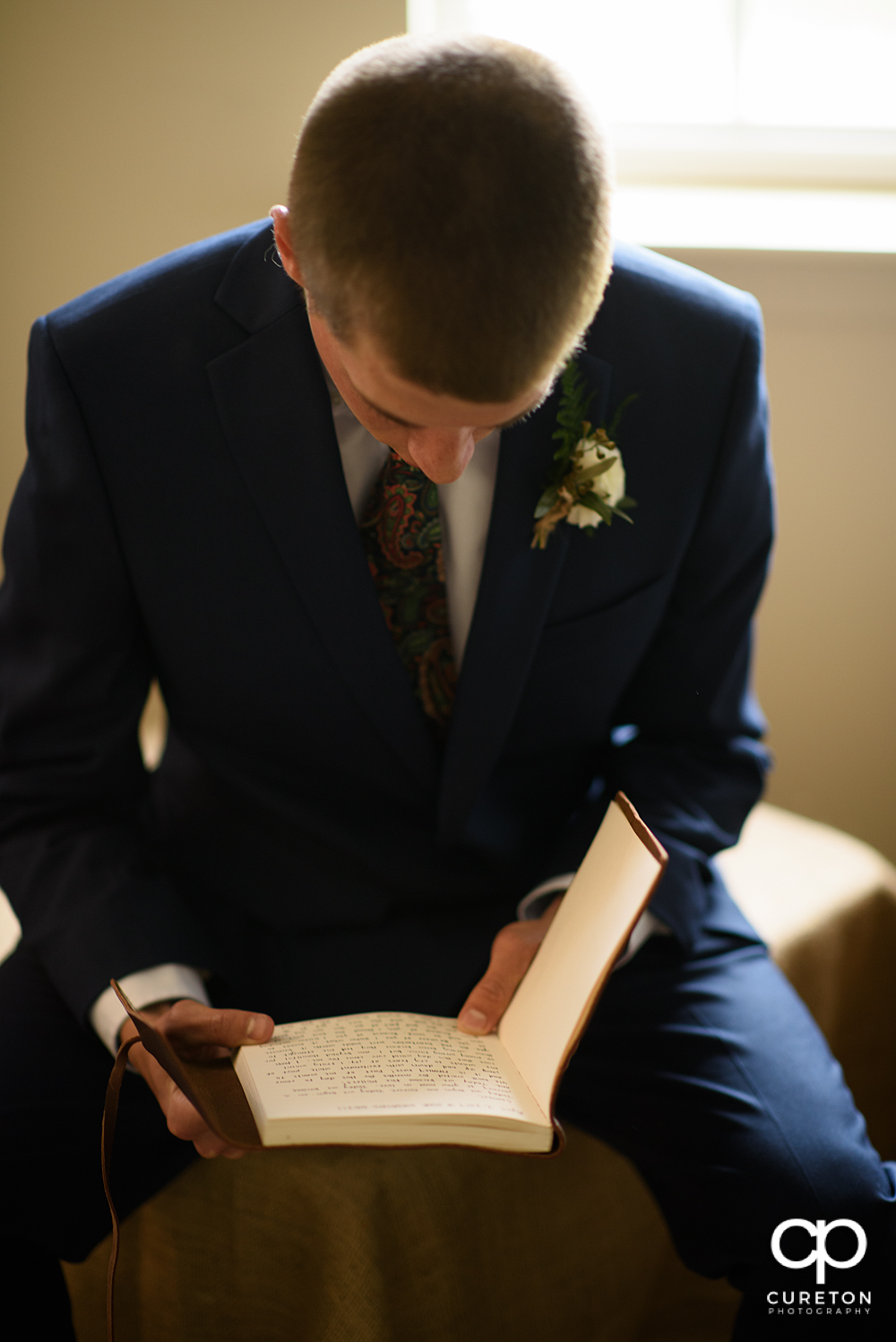 Groom reading a journal from his bride.