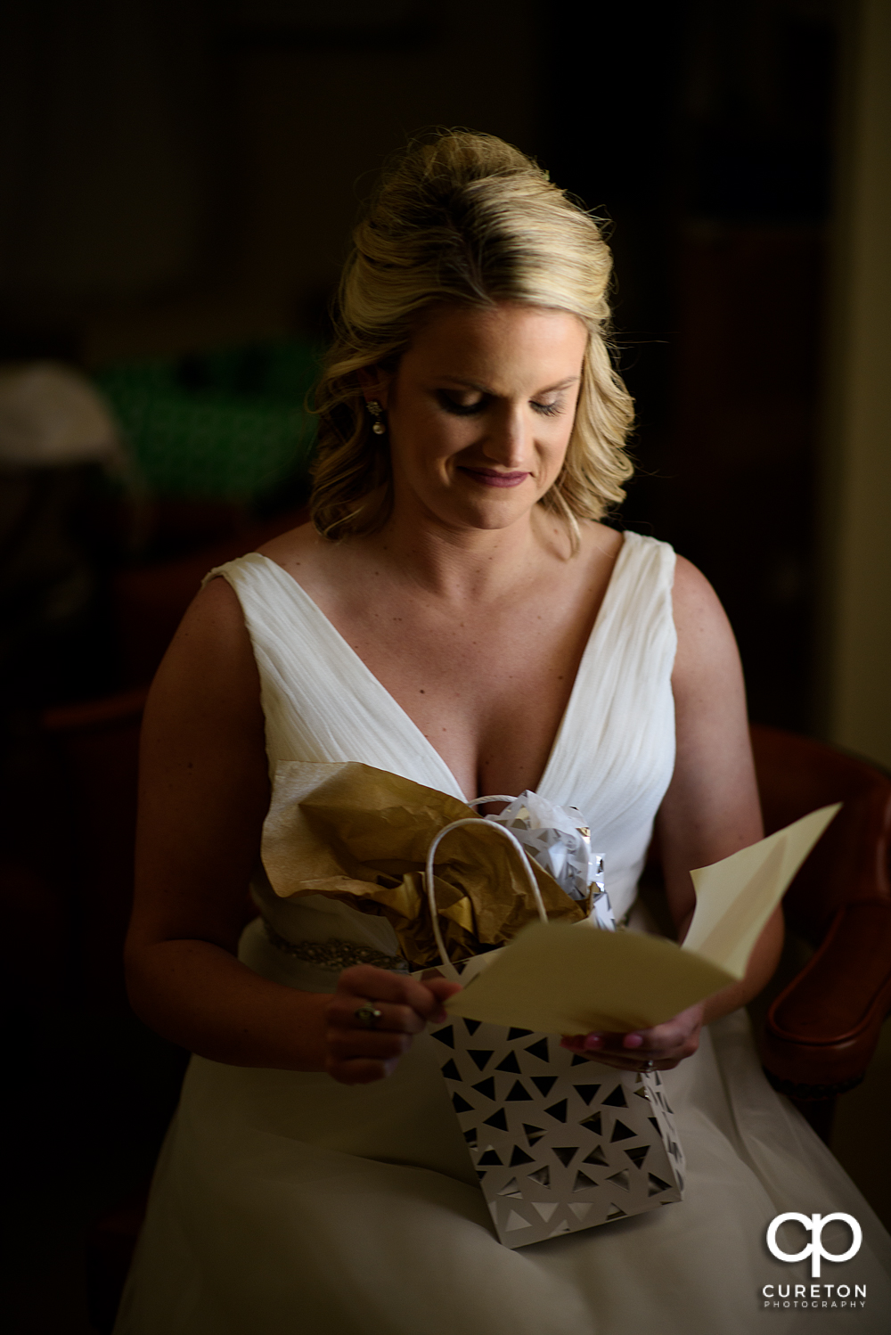 Bride looking at her present from the groom.