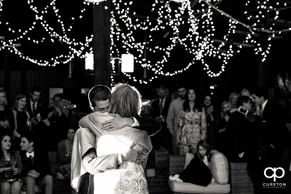 Groom and mother dance at the wedding reception.