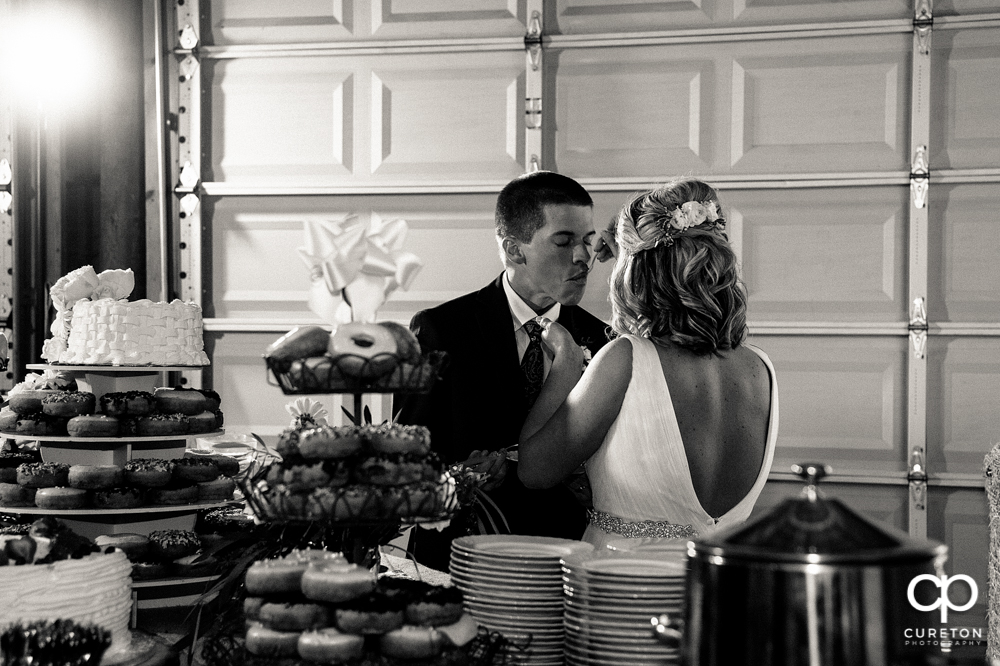 Bride and groom cutting the cake.