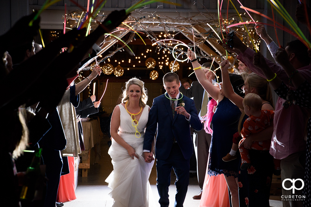 Bride and groom glow stick leave at Greenbrier Farms.